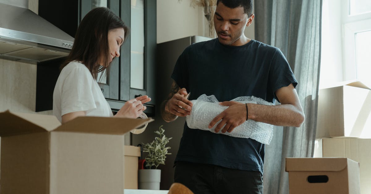 Plastic boxes on easyjet? - Man in Blue Crew Neck T-shirt Holding Woman in White Long Sleeve Shirt Plastic boxes on easyjet? - Man in Blue Crew Neck T-shirt Holding Woman in White Long Sleeve Shirt