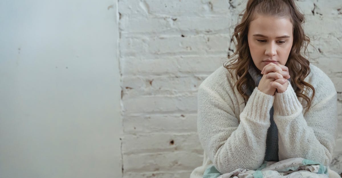 Poland : Effects of Negative Decision of Temporary Residence application on Future Schengen Visas [closed] - Young pensive female sitting near white wall and pondering unpleasant situation of argument with husband