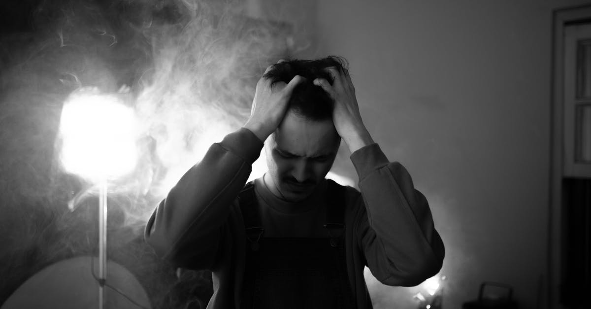 Poland : Effects of Negative Decision of Temporary Residence application on Future Schengen Visas [closed] - Black and white of upset male standing in room with lightning equipment and smoke while thinking about difficult decision at home