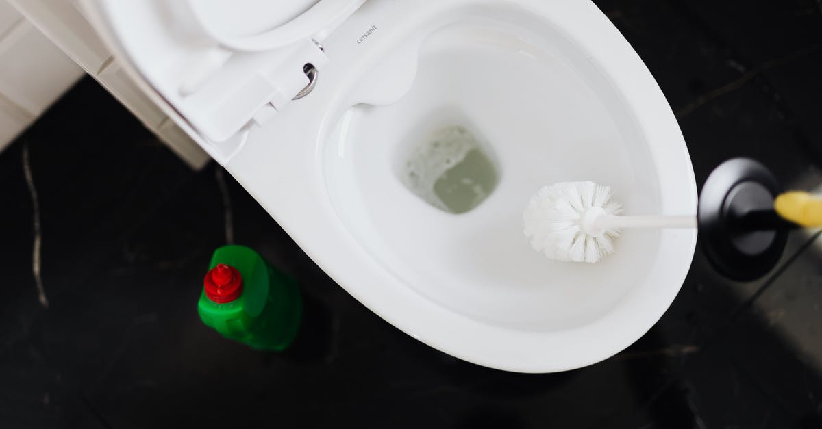 Polish Airports' fingerprint Process - From above crop anonymous person in yellow gloves cleaning toilet bowl with toilet brush and liquid detergent in green plastic bottle Polish Airports' fingerprint Process - From above crop anonymous person in yellow gloves cleaning toilet bowl with toilet brush and liquid detergent in green plastic bottle