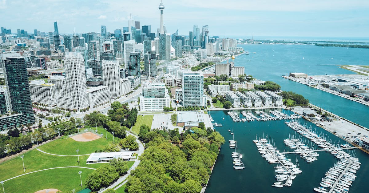 Port of Entry travelling from Toronto (Pearson) to US? - Architecture and harbor with moored boats of contemporary coastal city Port of Entry travelling from Toronto (Pearson) to US? - Architecture and harbor with moored boats of contemporary coastal city