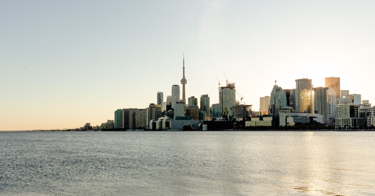 Port of Entry travelling from Toronto (Pearson) to US? - Contemporary cityscape against calm rippling seawater Port of Entry travelling from Toronto (Pearson) to US? - Contemporary cityscape against calm rippling seawater