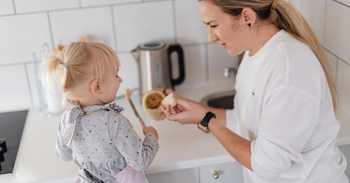Portuguese cuisine in Lisbon - Man in White Dress Shirt Holding Baby in White and Pink Floral Onesie Portuguese cuisine in Lisbon - Man in White Dress Shirt Holding Baby in White and Pink Floral Onesie