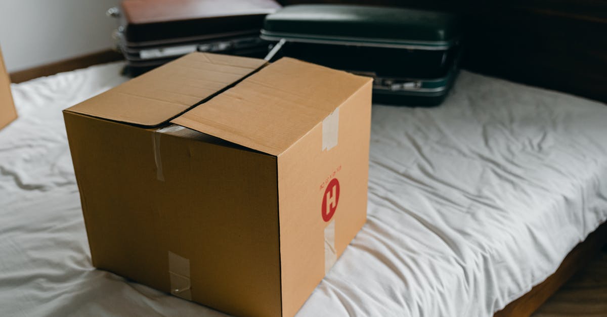 Possibility of delayed luggage during transfer at DXB - Carton box and suitcases for relocation on bed Possibility of delayed luggage during transfer at DXB - Carton box and suitcases for relocation on bed