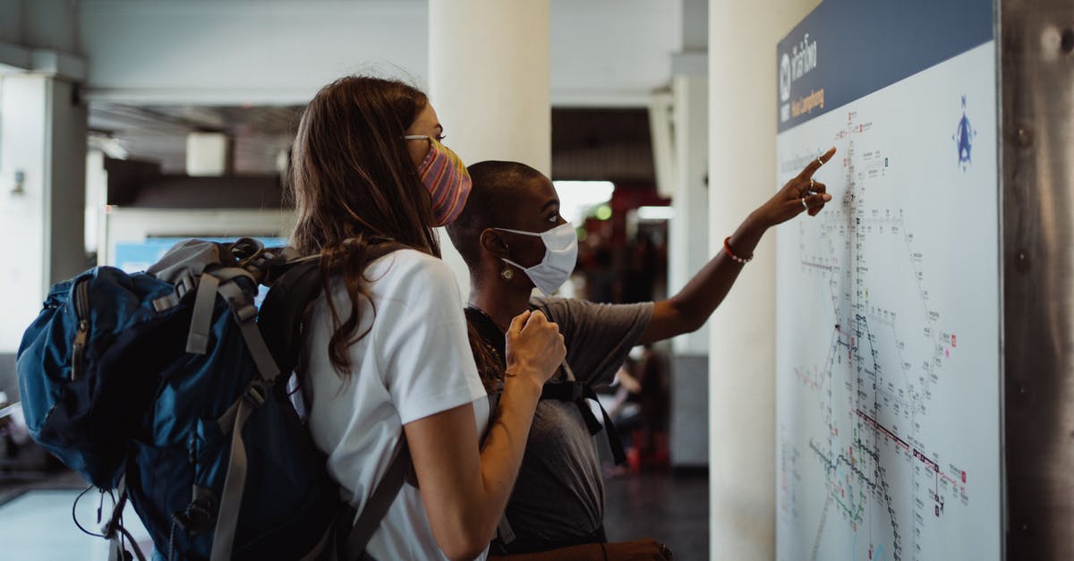 Possibility to Travelling together on returning [duplicate] - Two Women Looking at a Map