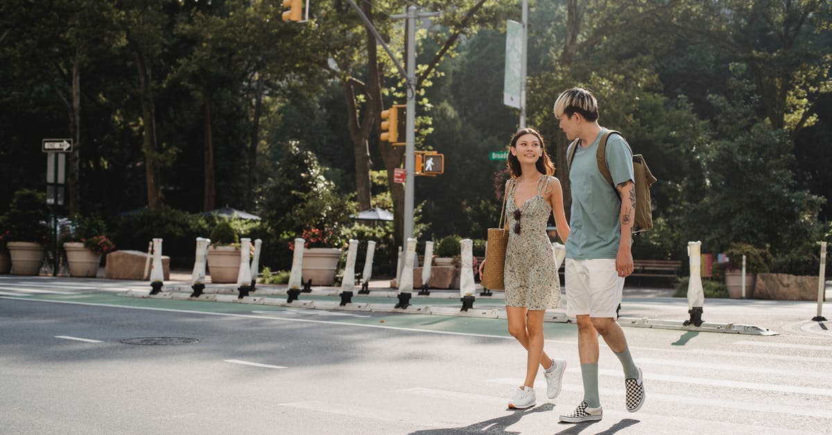 Possible ways to get from St. Petersburg to Helsinki (or the other way around) [closed] - Full body of happy young girlfriend carrying bag while walking on asphalt crosswalk with boyfriend
