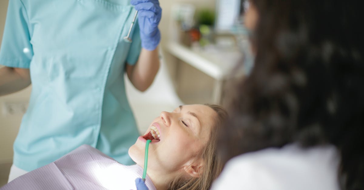 Practical information to prepare a visit to Kakslauttanen (igloo village) in Finland [closed] - Crop faceless female dentist in uniform holding mouth mirror while preparing for inspecting female patient teeth with assistant holding tube suction in patient mouth