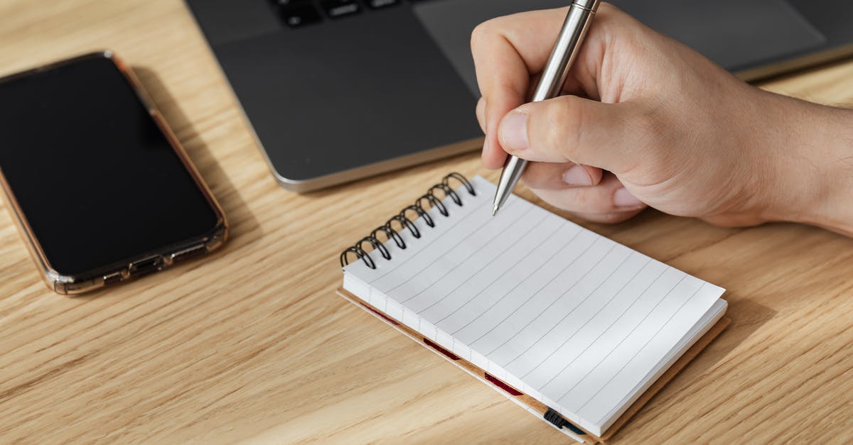 Prepaid Data Plan for cell phone in Italy - Crop person writing in notebook at workplace Prepaid Data Plan for cell phone in Italy - Crop person writing in notebook at workplace