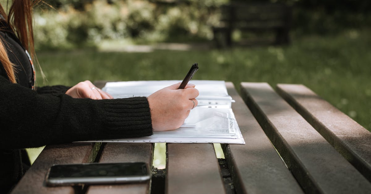 Prepaid Data Plan for cell phone in Italy - Anonymous female in casual clothing writing in copybook on wooden bench in sunlight on blurred background Prepaid Data Plan for cell phone in Italy - Anonymous female in casual clothing writing in copybook on wooden bench in sunlight on blurred background