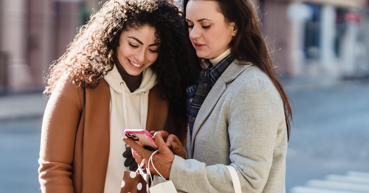 Prepaid mobile phone package for Frankfurt, Germany - Girlfriends in city street checking information on smartphone Prepaid mobile phone package for Frankfurt, Germany - Girlfriends in city street checking information on smartphone