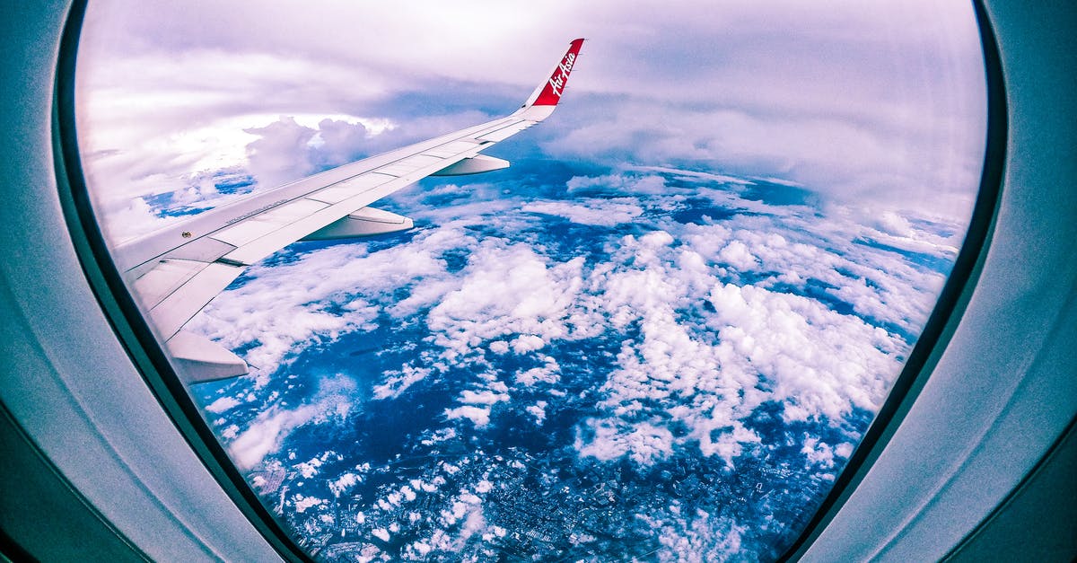 Previous ticket # for Jet Blue - Wide angle of rocky ground through cloudy sky and plane wing from window of aircraft Previous ticket # for Jet Blue - Wide angle of rocky ground through cloudy sky and plane wing from window of aircraft