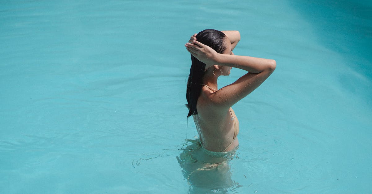 Price limits for self-arranged hotel after flight cancellation - Sensual young ethnic female touching hair while swimming in pool Price limits for self-arranged hotel after flight cancellation - Sensual young ethnic female touching hair while swimming in pool