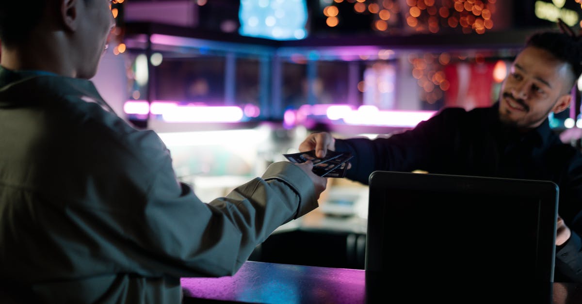 Price of self-transfer tickets versus separate tickets - Person in White Long Sleeve Shirt Holding Black Laptop Computer Price of self-transfer tickets versus separate tickets - Person in White Long Sleeve Shirt Holding Black Laptop Computer