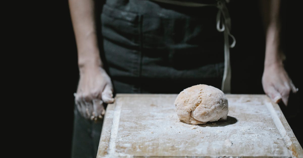Primary occupation for DS-160 Form (US visa) for a self-employed person - Baker in apron standing at table with dough