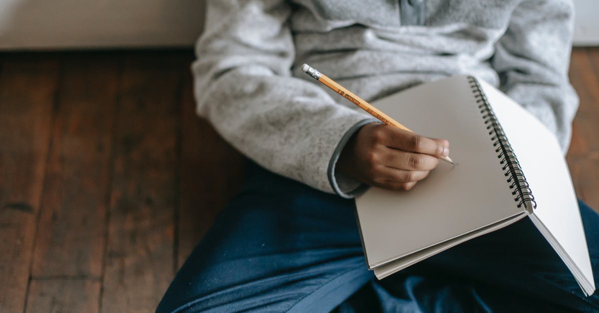 Primary occupation for the US visa - student or full-time employee?, I'm both - From above of African American schoolboy sitting on floor and writing with pencil in notebook