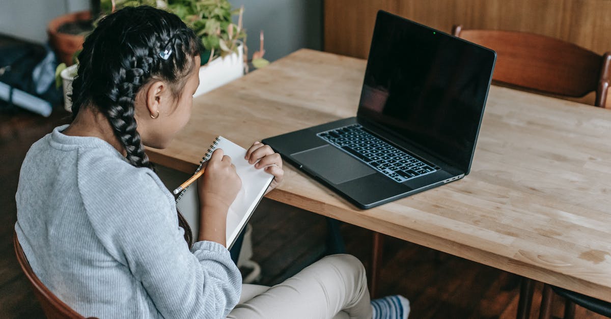 Primary occupation for the US visa - student or professional? - Ethnic girl writing notes studying with laptop Primary occupation for the US visa - student or professional? - Ethnic girl writing notes studying with laptop