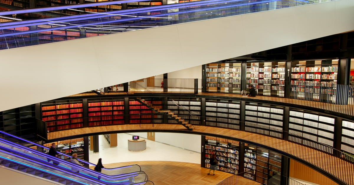 Problems associated with booking flights inside another set of flights? - Interior of modern library with escalators Problems associated with booking flights inside another set of flights? - Interior of modern library with escalators
