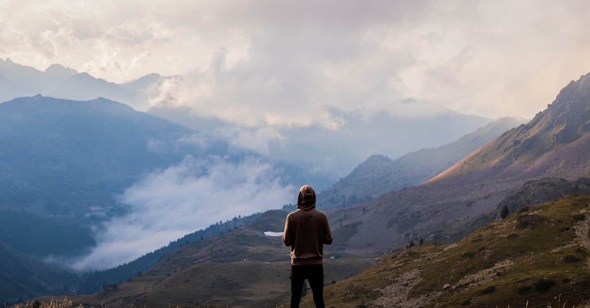 Procedure for traveling to the US on a green card - Person Wearing Brown Pullover and Black Jeans Standing on Mountain Top With The Scenic View Procedure for traveling to the US on a green card - Person Wearing Brown Pullover and Black Jeans Standing on Mountain Top With The Scenic View