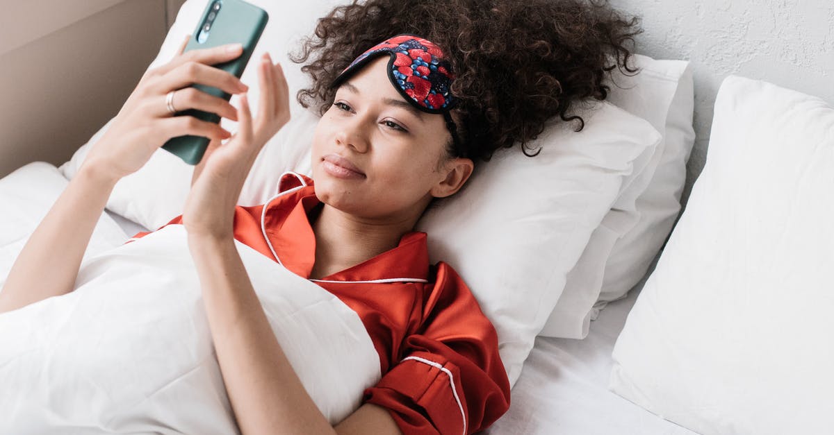 Processing time for EEA family permit and documents required - Woman in Red and White Collared Shirt Lying on Bed Using Iphone