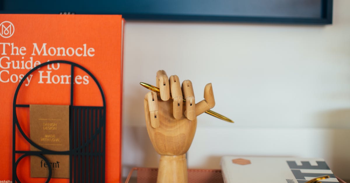 Prohibited item forgotten in hand luggage: what to do with it? - Encyclopedia placed near wooden decorative hand shaped pen holder