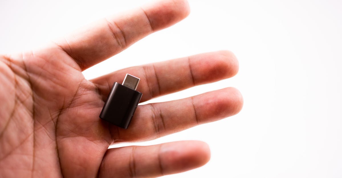 Prohibited item forgotten in hand luggage: what to do with it? - Crop hand with flash drive