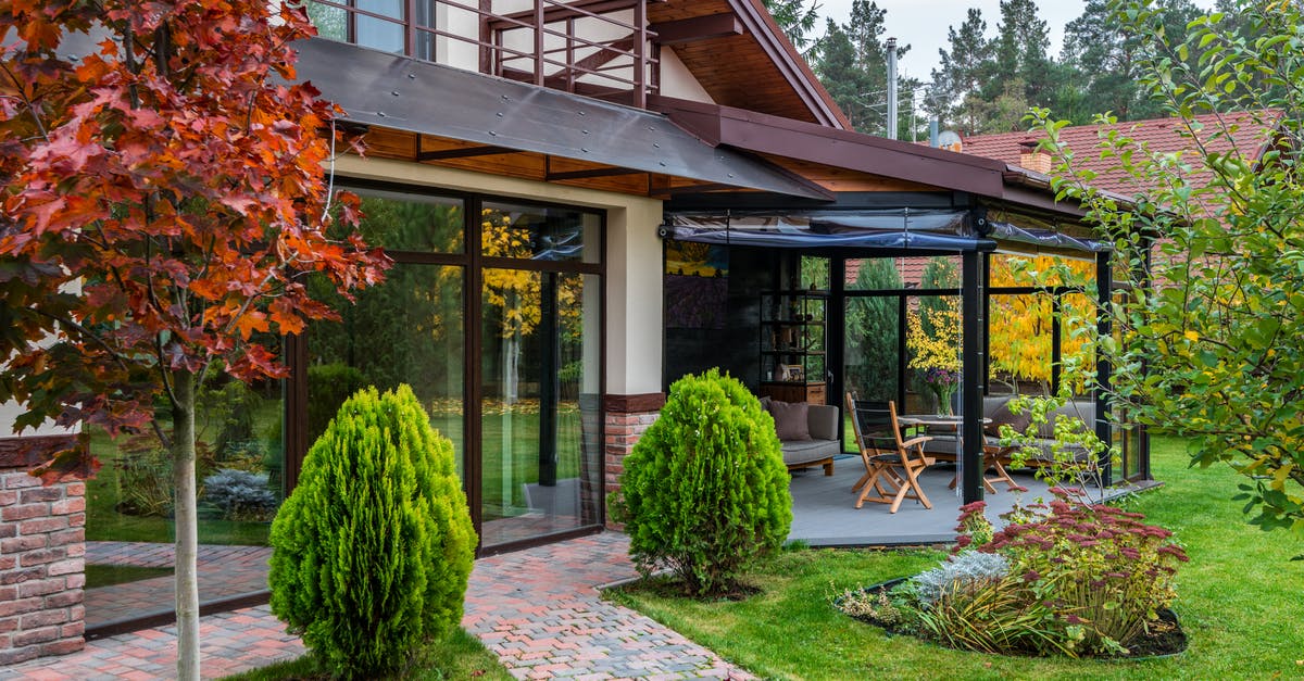 Proof of Accommodation in England - Exterior of contemporary house with cozy terrace and garden with bushes and trees on autumn day Proof of Accommodation in England - Exterior of contemporary house with cozy terrace and garden with bushes and trees on autumn day