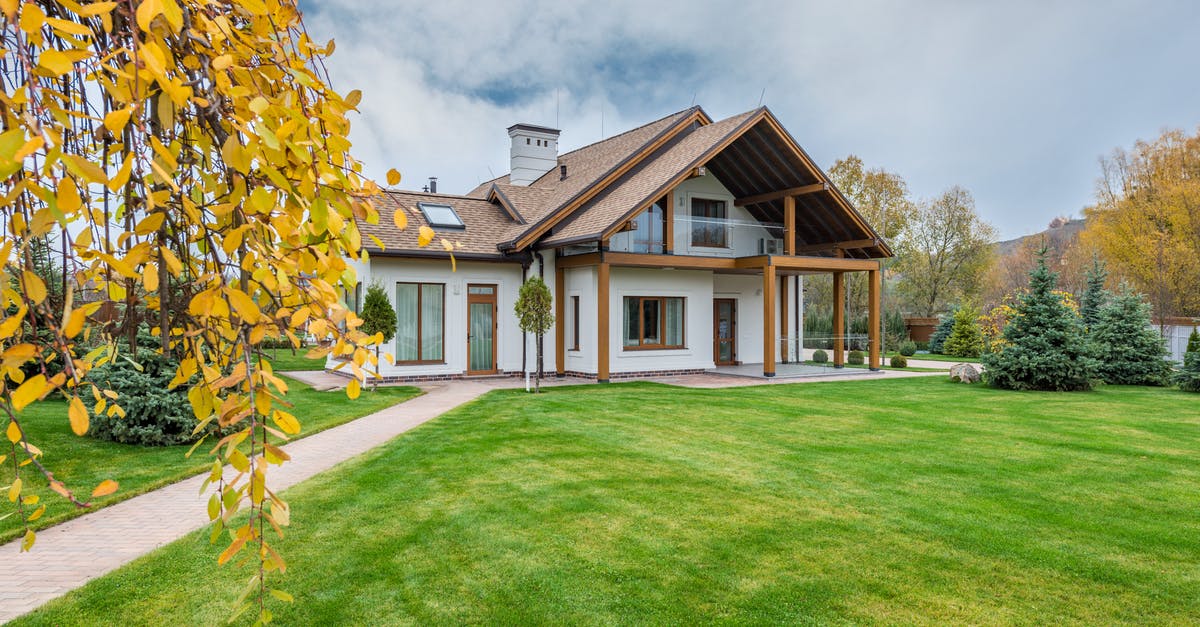 Proof of Accommodation in England - Exterior of residential suburban cottage with balcony surrounded with lush green plants and trees Proof of Accommodation in England - Exterior of residential suburban cottage with balcony surrounded with lush green plants and trees