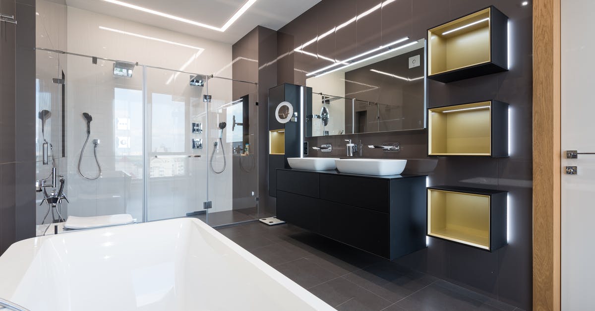 Proper technique to wash laundry in hotel sink? - Interior of contemporary bathroom with glass shower cabin and ceramic bathtub in front of shelves hanging near sinks and mirrors Proper technique to wash laundry in hotel sink? - Interior of contemporary bathroom with glass shower cabin and ceramic bathtub in front of shelves hanging near sinks and mirrors