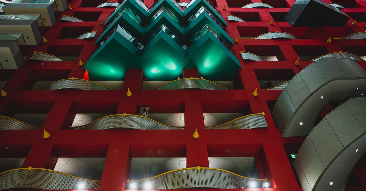 Public transporation from Kansai Airport to Osaka - From below of geometric shapes of contemporary building of business and trade center in Osaka Public transporation from Kansai Airport to Osaka - From below of geometric shapes of contemporary building of business and trade center in Osaka