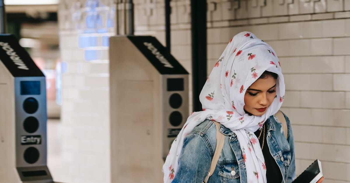 Public Transport planner for Hanover (Hannover)? - Calm Muslim woman with copybook wearing floral headscarf wearing jeans jacket with backpack entering subway station through automatic turnstile Public Transport planner for Hanover (Hannover)? - Calm Muslim woman with copybook wearing floral headscarf wearing jeans jacket with backpack entering subway station through automatic turnstile