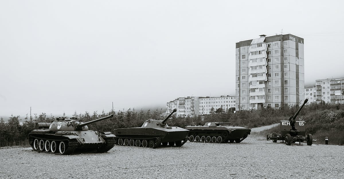 Public transport to Jotunheimen National Park - Black and white of monuments of various military vehicles on square in city Public transport to Jotunheimen National Park - Black and white of monuments of various military vehicles on square in city