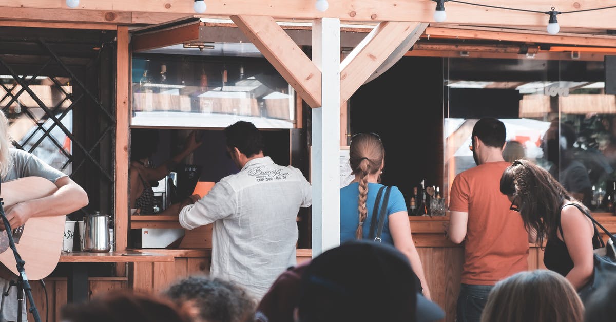 Purchase Paris Visite pass from Orly airport on a public holiday - People gathering near counter at festival Purchase Paris Visite pass from Orly airport on a public holiday - People gathering near counter at festival