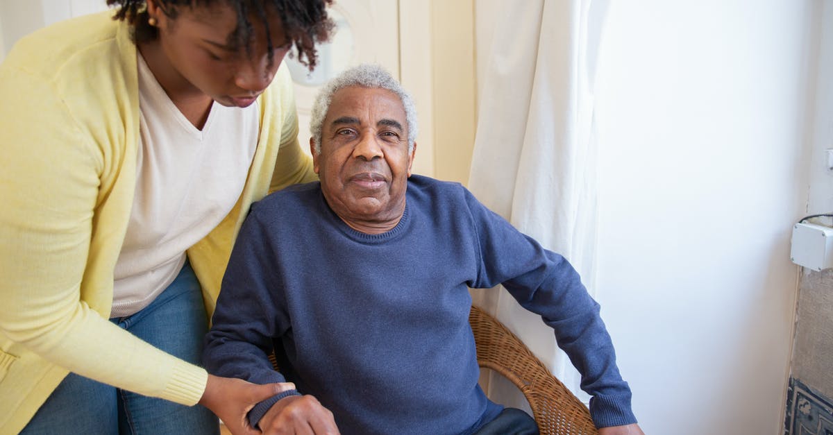 Putting a hold on an airline seat - Woman Assisting Elderly Man Putting a hold on an airline seat - Woman Assisting Elderly Man
