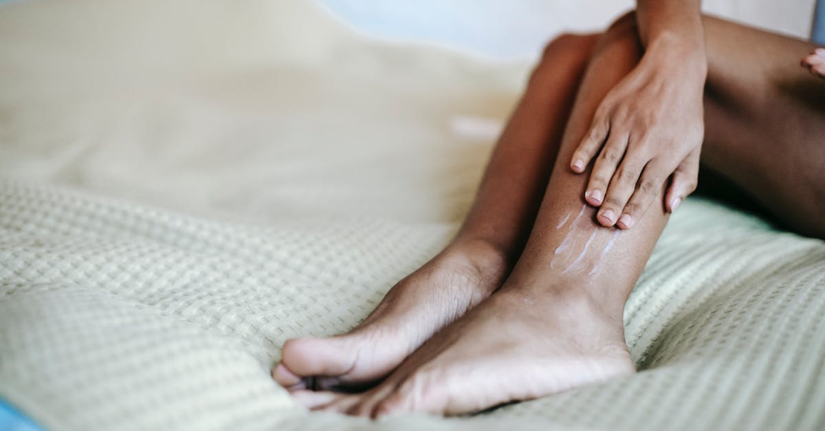 Qantas MEL-SYD-SCL: is the first leg international or domestic - Crop woman moisturizing legs on bed Qantas MEL-SYD-SCL: is the first leg international or domestic - Crop woman moisturizing legs on bed