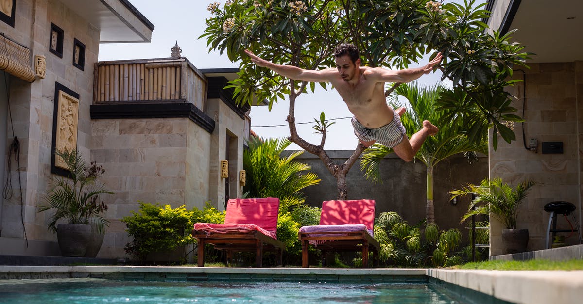 Qatar Airways Free stopover/complimentary hotel - Man Jumping on Pool Qatar Airways Free stopover/complimentary hotel - Man Jumping on Pool