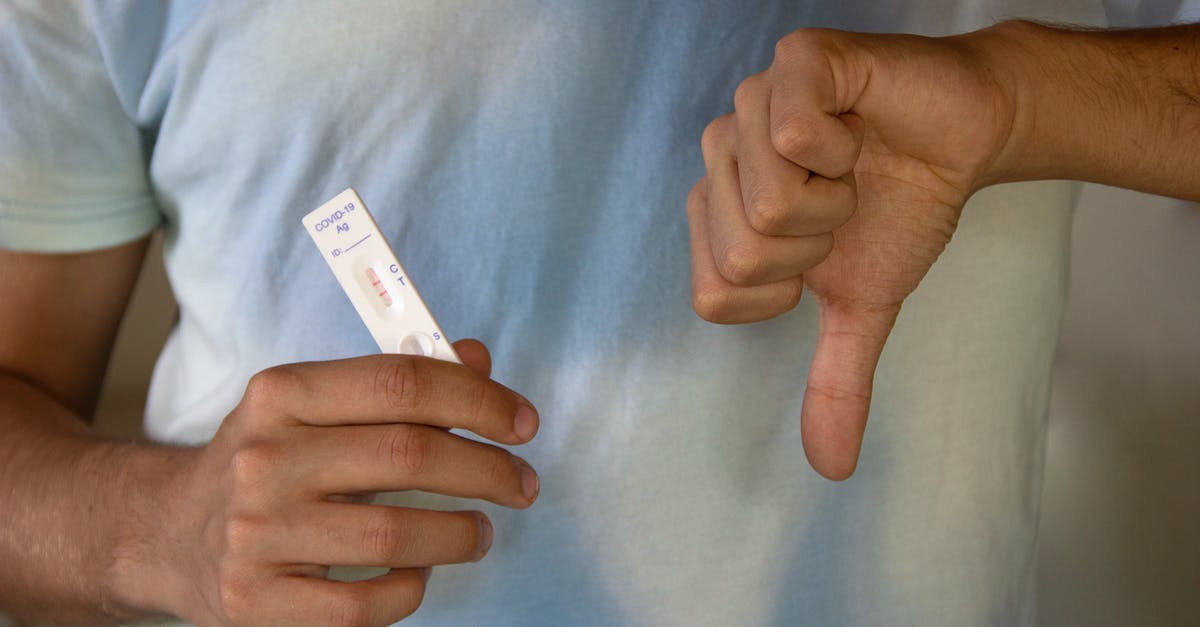 quarantining in the UK pending negative COVID-19 PCR test results - A Person Holding an Antigen Rapid Test Result quarantining in the UK pending negative COVID-19 PCR test results - A Person Holding an Antigen Rapid Test Result