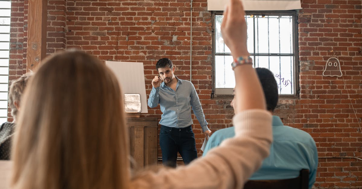 Question regarding having a 21 day long stay in the Netherlands first, then studying in France [duplicate] - A Bearded Man Pointing the Pen at the Person Raising Hand 