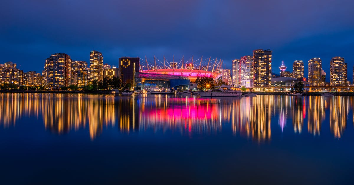 Questioned while in transit in Vancouver - Long exposure panoramic shot from colorful downtown Vancouver at night Questioned while in transit in Vancouver - Long exposure panoramic shot from colorful downtown Vancouver at night
