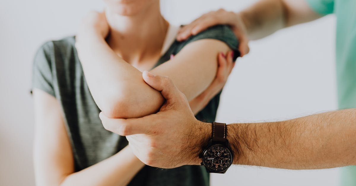 Quitting job to visit my UK boyfriend for longer - Crop unrecognizable chiropractor examining arm joint of female patient Quitting job to visit my UK boyfriend for longer - Crop unrecognizable chiropractor examining arm joint of female patient