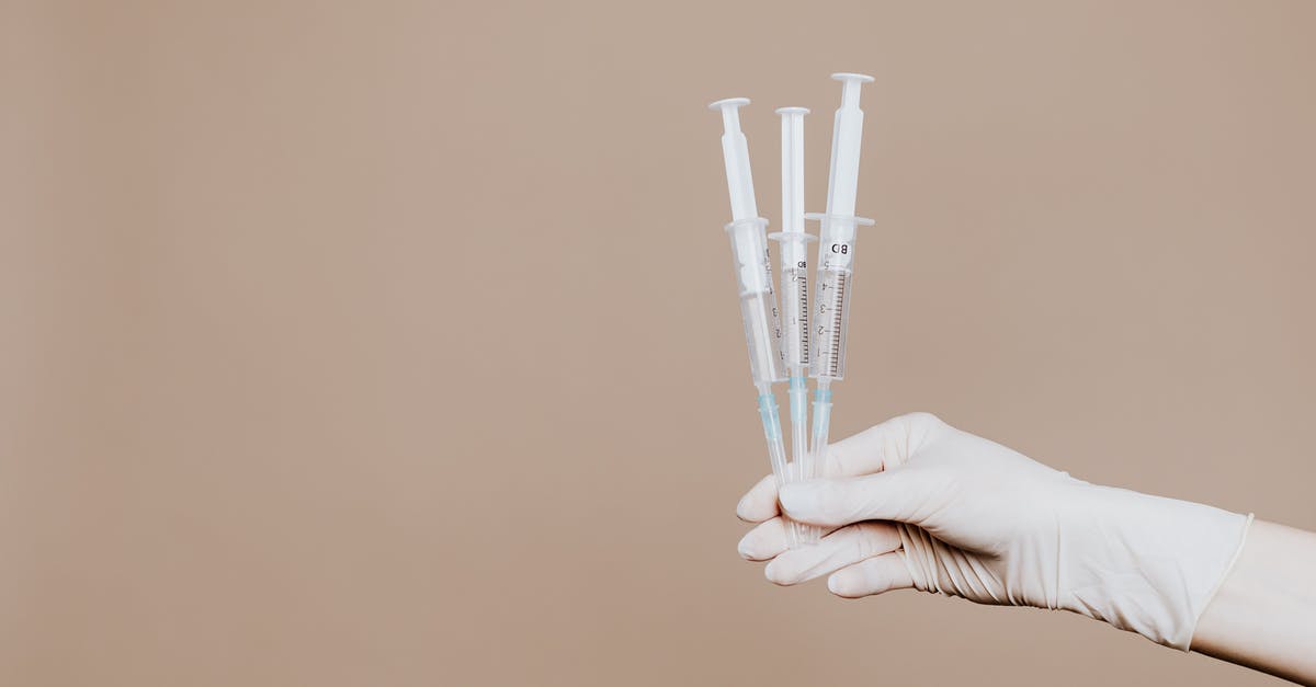 Rabies Injections - Visiting Phnom Tamao - Person Holding Three Syringes with Medicine Rabies Injections - Visiting Phnom Tamao - Person Holding Three Syringes with Medicine