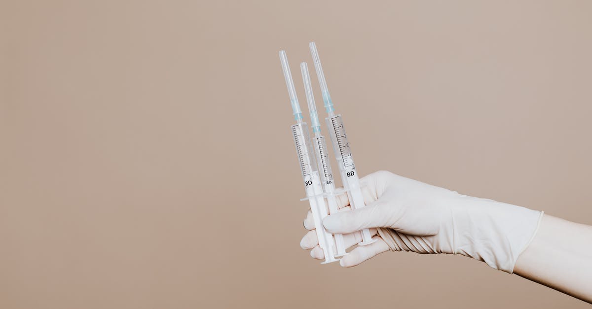 Rabies Injections - Visiting Phnom Tamao - Person Holding Three Syringes with Medicine Rabies Injections - Visiting Phnom Tamao - Person Holding Three Syringes with Medicine