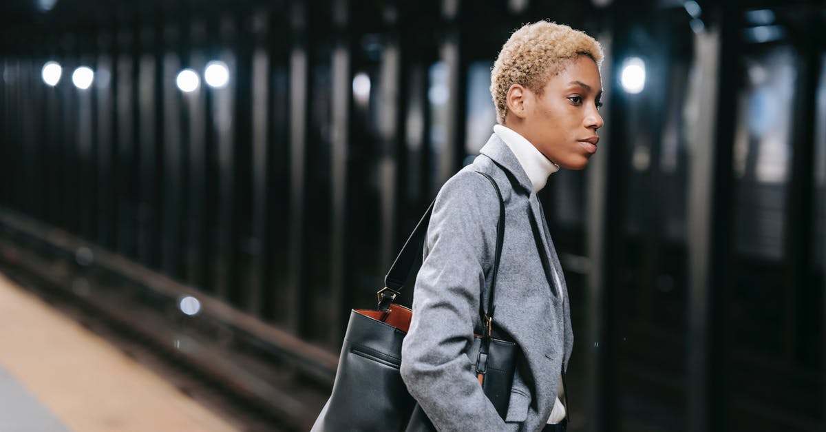 Radio program with public transport focus by country - Calm elegant young black lady standing on platform in underground Radio program with public transport focus by country - Calm elegant young black lady standing on platform in underground