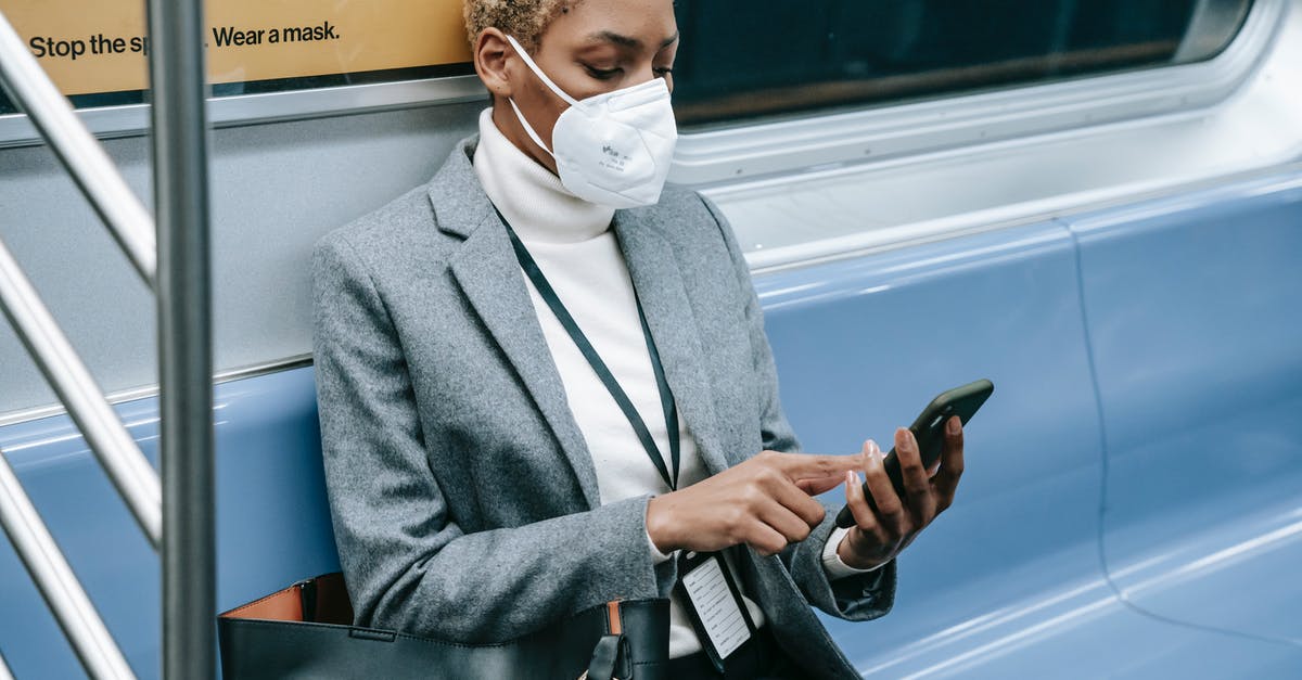 Radio program with public transport focus by country - Crop black focused woman using smartphone in metro train Radio program with public transport focus by country - Crop black focused woman using smartphone in metro train