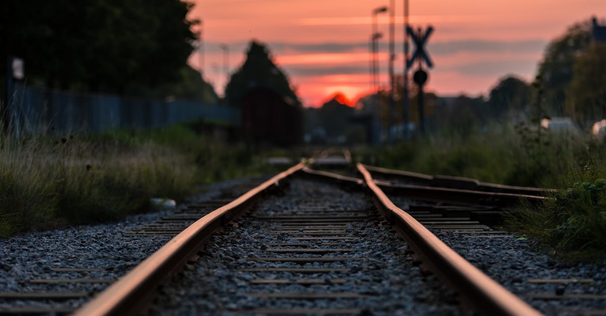 Rail travel between Azerbaijan and Georgia - Shallow Focus Photography of Railway during Sunset Rail travel between Azerbaijan and Georgia - Shallow Focus Photography of Railway during Sunset