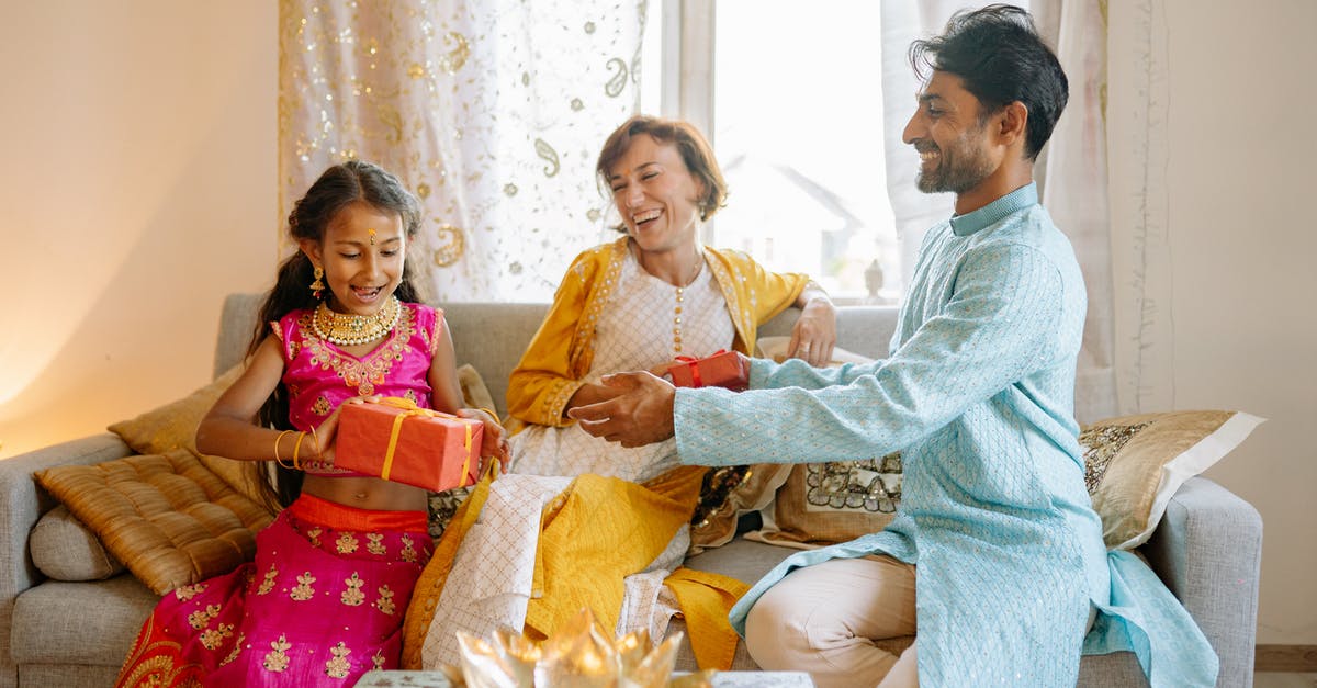 Receiving visa after entering Thailand - Woman in Blue Long Sleeve Shirt Sitting Beside Woman in Red and Yellow Sari Receiving visa after entering Thailand - Woman in Blue Long Sleeve Shirt Sitting Beside Woman in Red and Yellow Sari