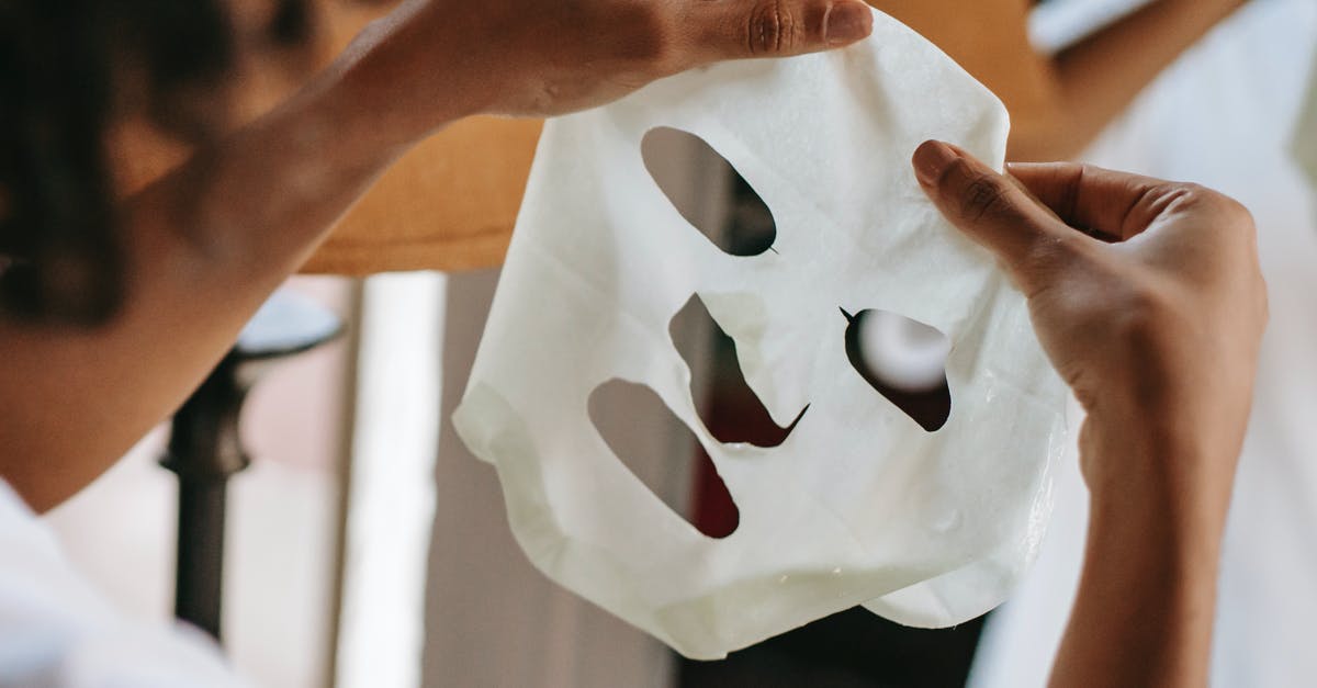 Recently naturalized American visiting the UK, previously denied visa. Apply for entry clearance? - Ethnic female holding sheet mask at home