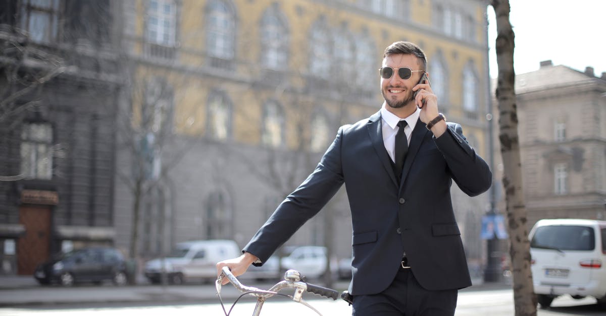 Recommended software for communicating / documenting whilst on a bike tour [duplicate] - Man in Black Suit Jacket and Black Dress Pants Holding Red Bicycle