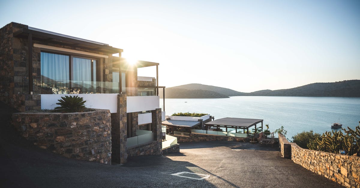 Re-enter Schengen with a residence card - Sun Piercing of Brown Concrete House Near Sea Re-enter Schengen with a residence card - Sun Piercing of Brown Concrete House Near Sea