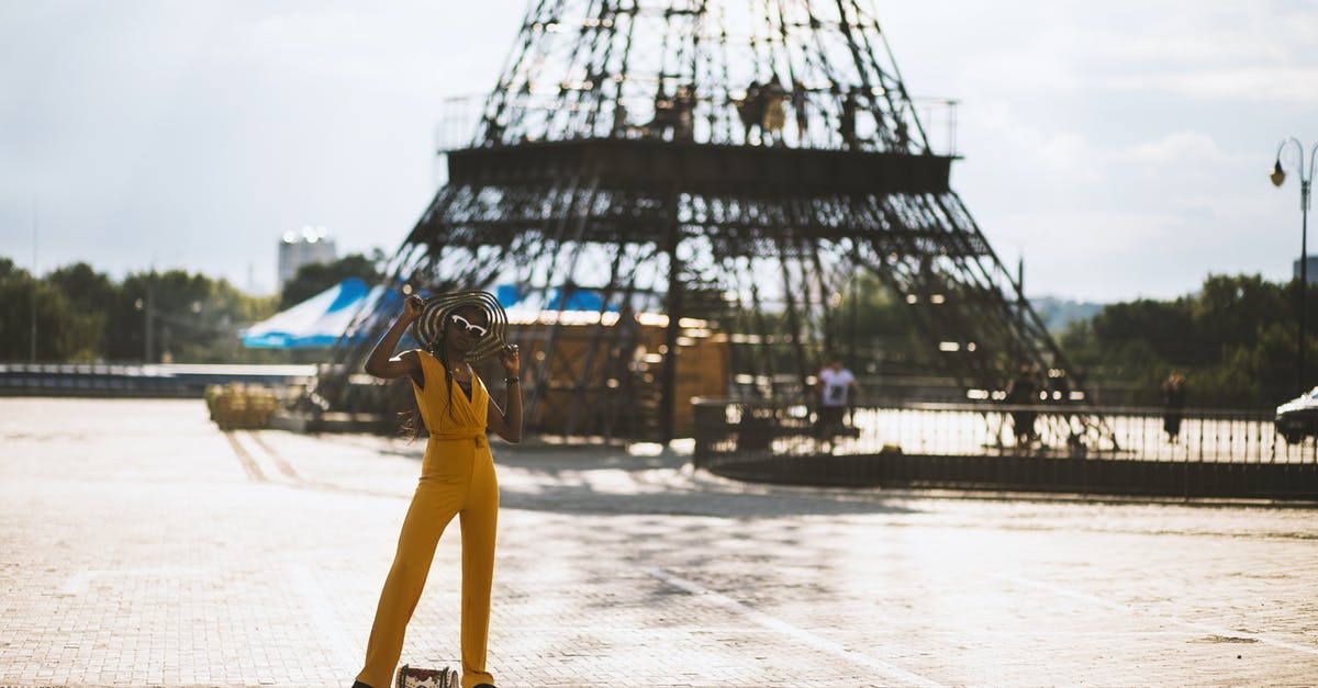 Re-entering France with an American passport - Woman Wearing Orange Jumpsuit While Holding Hat Re-entering France with an American passport - Woman Wearing Orange Jumpsuit While Holding Hat