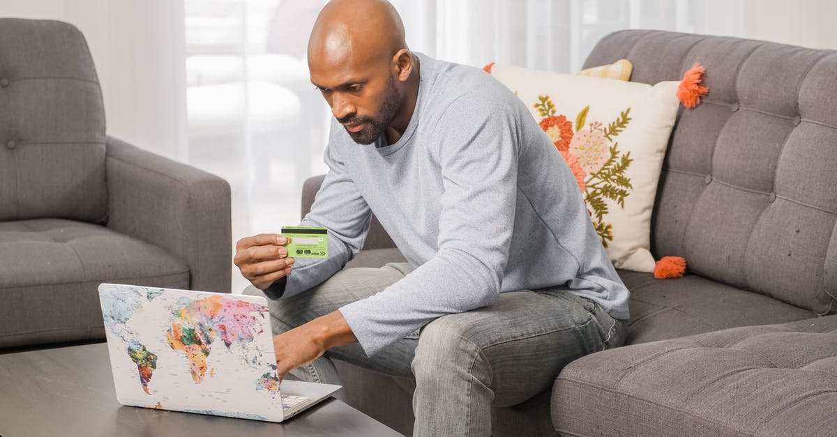 Refund Oyster Card online - Man in Gray Sweater Sitting on Gray Couch Refund Oyster Card online - Man in Gray Sweater Sitting on Gray Couch